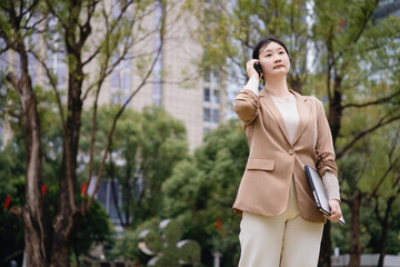 Businesswoman Taking Call in Urban Park Setting