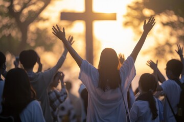 A crowd of various people are raising their two hands to the air to praise the Lord and  gathered around a wooden cross settled at a mound among the cloudy sky. Religion and faith in God.