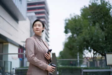 Confident Businesswoman in Urban Environment with Phone