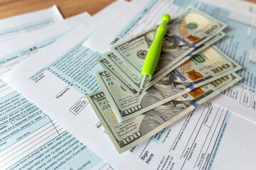 Fototapeta premium 1040 Individual Income US tax form with dollars business concept
