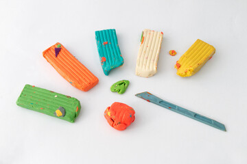 Homemade plasticine, play dough on a white background. Molding clay or slime. Homemade clay.