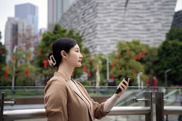 Modern Woman Enjoying Urban Scenery with Smartphone