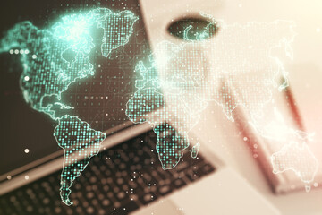 Double exposure of abstract digital world map on laptop background, research and strategy concept