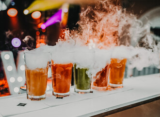 glasses with colorful drinks with dry ice, smoky drinks,