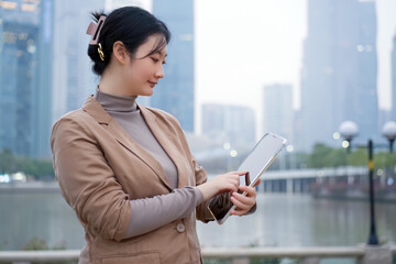 Professional Woman Using Tablet in Urban Landscape
