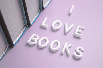 The word i love books is elegantly displayed in white font on a striking purple backdrop
