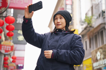 Woman Taking Selfie in Urban Asian Setting