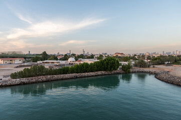Fototapeta premium Perspective of skyscraper towers and bay cityscape skyline of Abu Dhabi, sunrise in UAE.