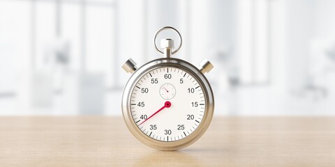 Silver classic stopwatch on blured office background