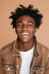 Happy cheerful young African American gen z guy isolated on beige background. Smiling funny ethnic teen student, cool curly generation z teenager laughing with white perfect teeth
