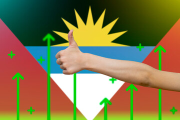 Antigua And Barbuda flag with green up arrows, country statistics concept,  finger thumbs up front 