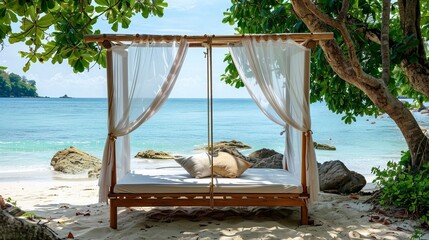 wooden swing with a mattress and pillows under a canopy on the tropical beach