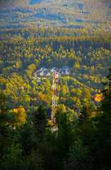 big radio tower in the forest on moutains