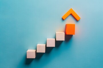 Minimalistic composition of ascending rectangular blocks on light blue background, top block in vibrant orange