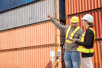 shipping company worker together with caucasia independent inspector using digital tablet to inspect safety of container boxes at port terminal,concept of cargo container inspection,shipping industry