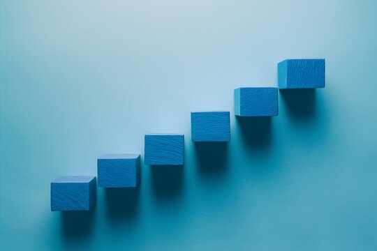 Minimalist design featuring a sequence of blue rectangular blocks on light blue backdrop symbolizing progression