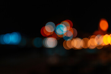 Unfocused blurred photo of city lights in the dark at night.