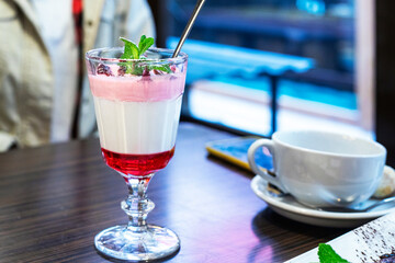fruit dessert panna cotta with a sprig of mint on the table with tea