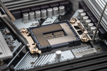 High-resolution image of an open CPU socket on a modern motherboard, detailing the intricate pin...