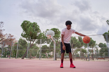 Basketball player training on a court in the city