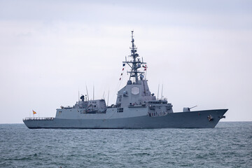 Naklejka premium Large grey modern warship sailing. NATO ship sailing at sea. Naval Forces
