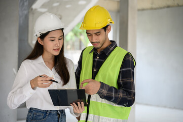 Female civil engineer with personal safety equipment check and consult with construction site foreman technician for inspect building construct process during follow up process. Engineering concept.