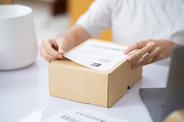 The business of shopping online. Attaching Shipping Label to a Parcel.