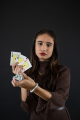  woman holding four aces in her hand isolated on black