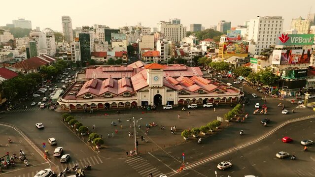 Drone shot of the famous Ben Thanh Market in Ho Chi Minh City, Vietnam with street traffic