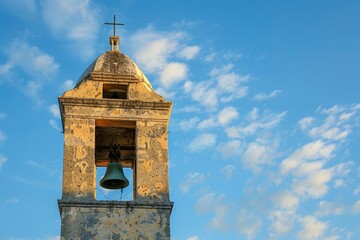 Church bell tower against blue sky. Copy space for text