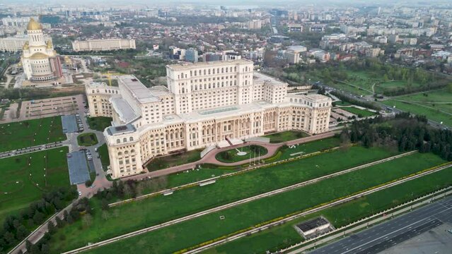 Aerial drone footage of the People's Palace in Bucharest Romania. Romanian Parliament seen from above on a green spring day. Brutalist architecture landmark of post-communist Europe.
