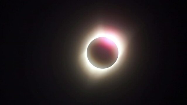 Pink glow of chromosphere heralds the diamond ring effect during a total solar eclipse.