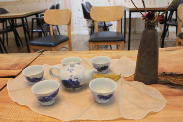 empty teapot and cups on a wooden table