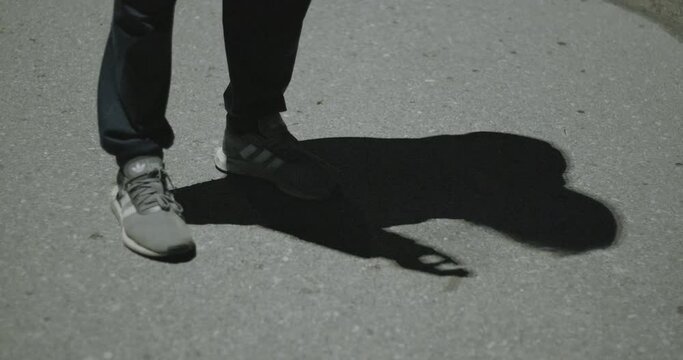 Man's shaddow smokes at street