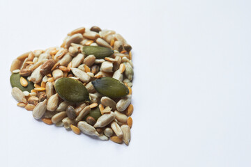 Healthly Eating Shot With Nuts And Seeds In Shape Of A Heart On White Background
