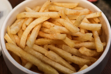 close up of a white bowl of french fries