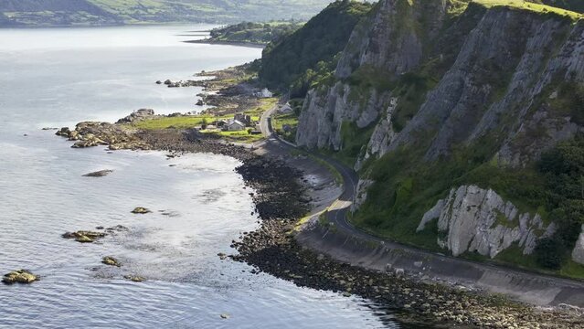 Garron point on The Antrim Coast Road in Northern Ireland. Part of the Causeway Coastal Route. Aerial 50fps UHD
