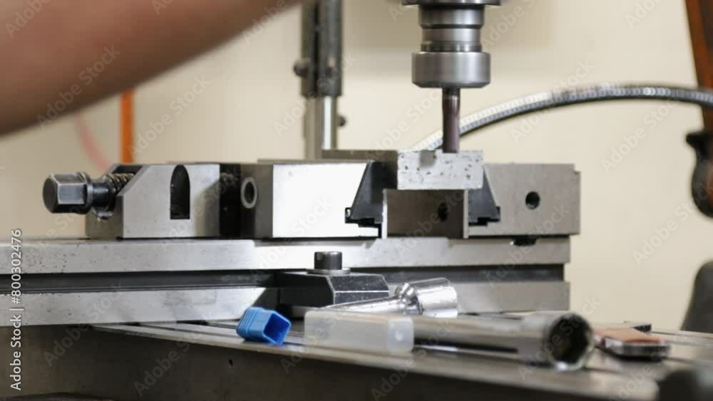 Poster close-up of a milling machine in operation with sharp metal parts