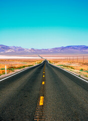 Lonely road with blue sky in Nevada, United States