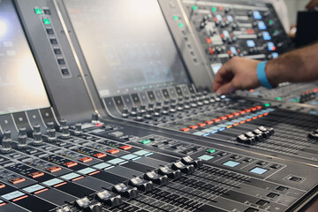 Sound engineer hands adjusting control sound mixer in recording, broadcasting studio