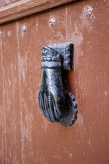 detail of iron work on a typical door handle and knocker in Menorca