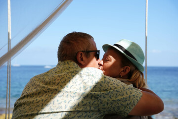 mature couple kissing in the spanish coast. Carefree family