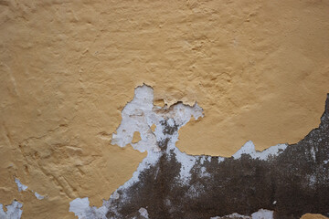 detail of stone and cement wall with peeling paint texture
