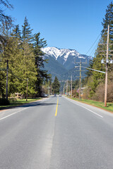 Street in small town in Canada with bluesky and snow top mountain