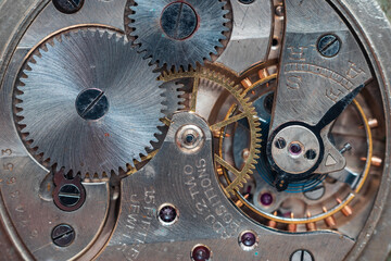 Pocket watch mechanism. Mechanical steel clockwork with cogwheel and screw
