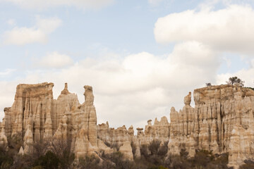 Fototapeta premium A rocky landscape with a few small hills and mountains. The sky is cloudy, and the sun is not visible
