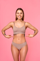 Fototapeta premium Cosmetology, beauty and spa treatment. Woman in lingerie on pink background.