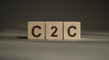 Wooden cubes with the word C2C on financial background