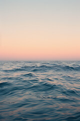 Obraz premium A close-up of a wave on the water surface of the ocean. Boundless sea, calm background for presentation or backing. Ocean waters, splashes.