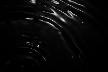 Image of black water surface with waves.